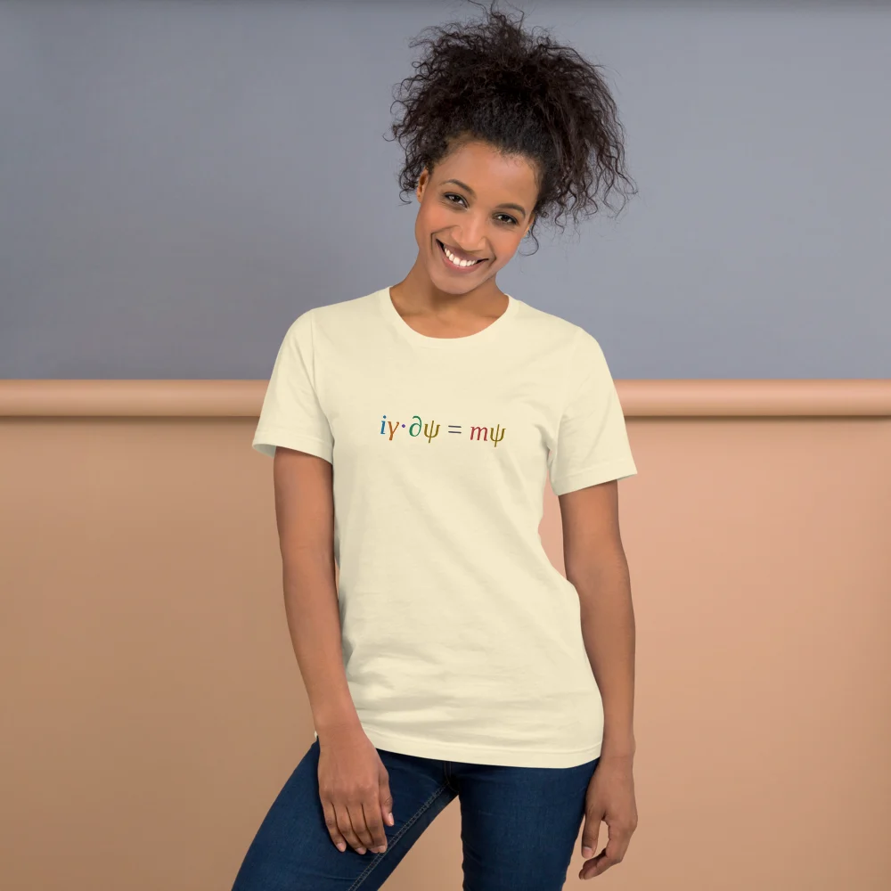A smiling woman wearing the natural t-shirt, the coloured equation across her chest.